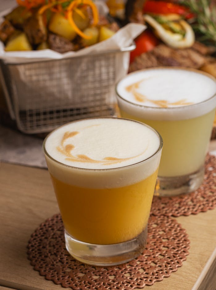 Delight in vibrant Peruvian cocktails featuring fresh fruit garnish. Perfect for summer gatherings.
